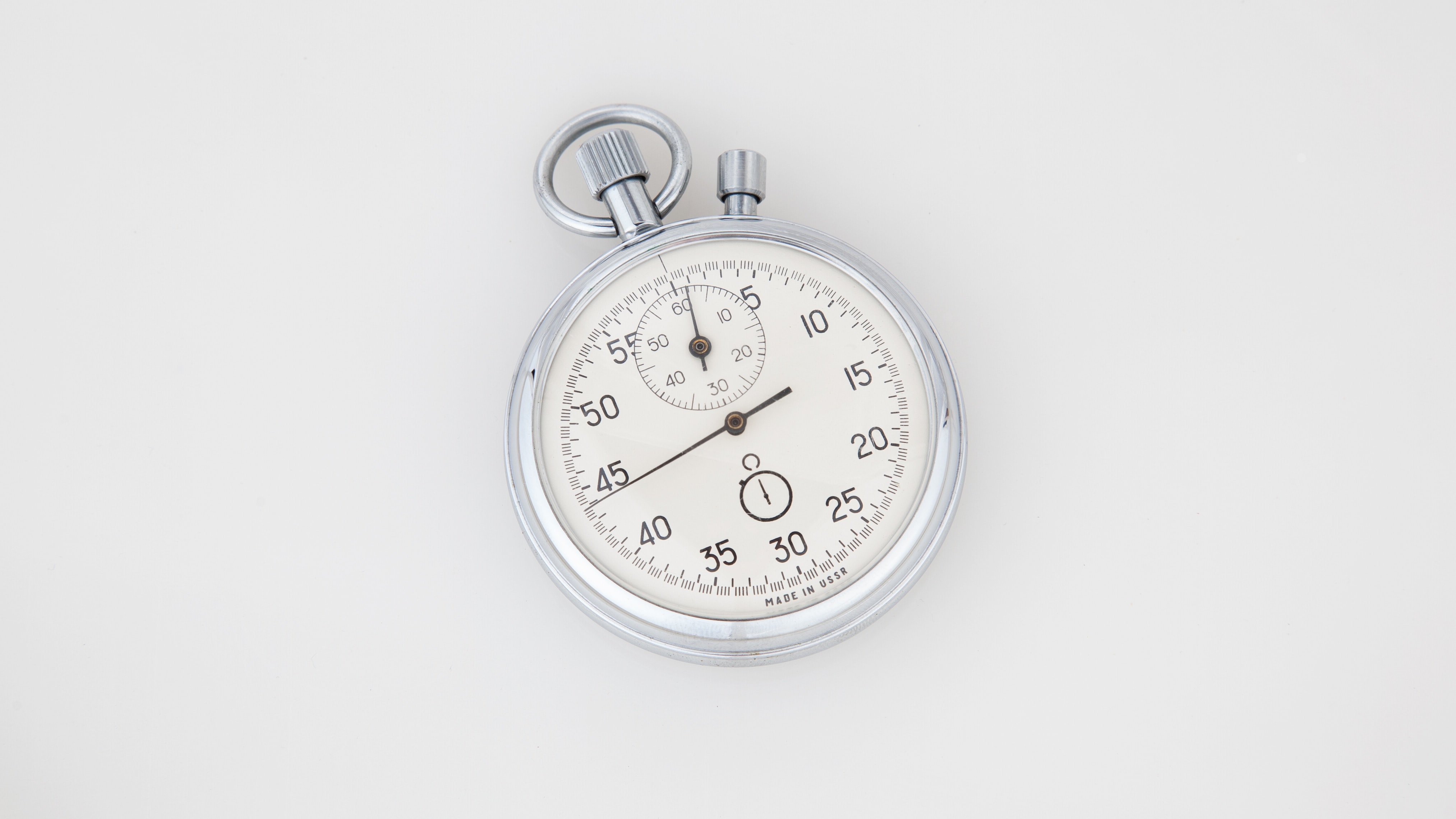 Old school stopwatch, silver, lying on a white background